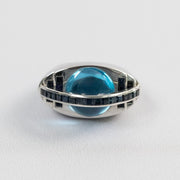 Bague forme œil en or blanc 18 carats, topaze bleue cabochon et saphirs baguettes, vue de face