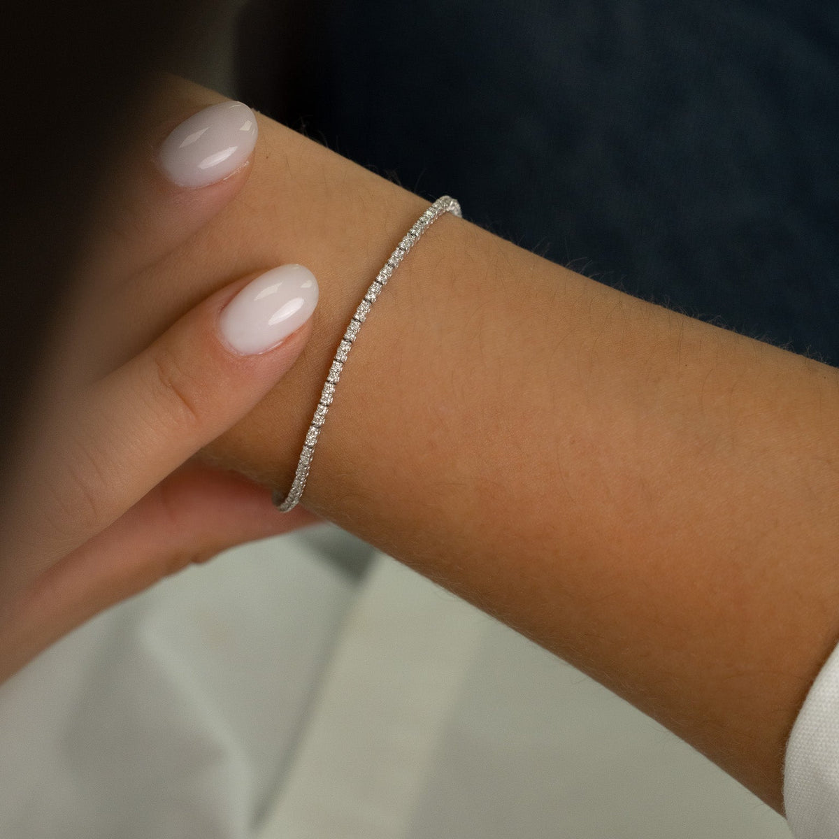 Profil du bracelet tennis fin en or blanc montrant la finesse de la ligne